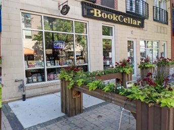 A book cellar store front with plants in the center.